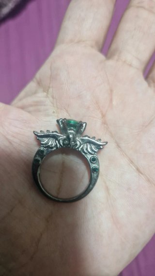 Anillo con piedras verdes y detalles plateados