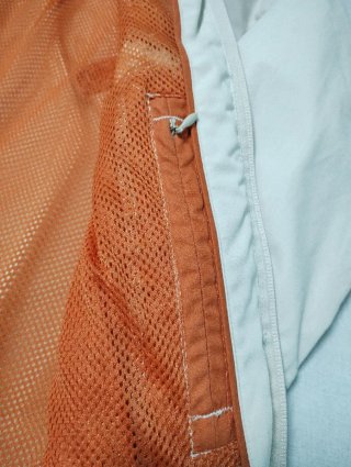 Chaqueta cortavientos Quechua beige y naranja