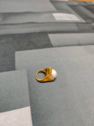 Anillo dorado con perla blanca