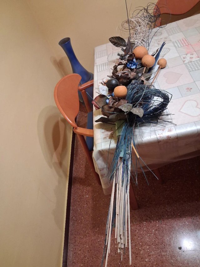 Jarrón azul con flores secas y ramas