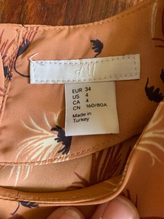 Bluse con peplo color rosa pesca floreale da donna