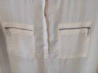 Blusa blanca manga 3/4 con bolsillos