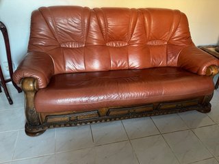 Sofá de cuero marrón con detalles de madera