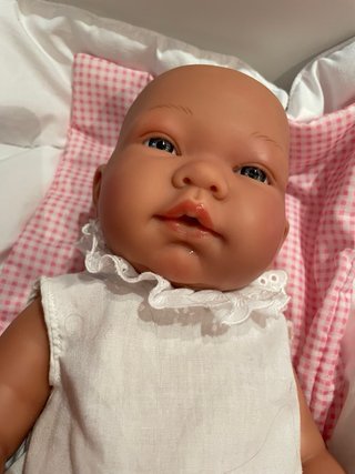 Muñeca bebé con cuna