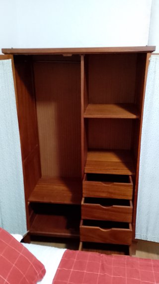 Armario de madera con puertas de madera y tela.