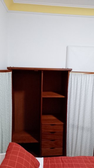 Armario de madera con puertas de madera y tela.