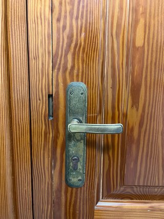 Puerta de madera con cristal y reja