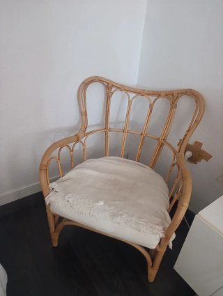 Sillón de mimbre con cojín blanco