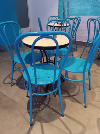 Sillas metálicas azules recién pintadas