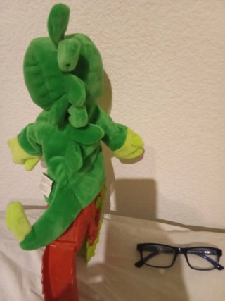 Marioneta de dinosaurio verde