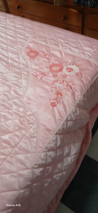 Colcha rosa con bordado floral