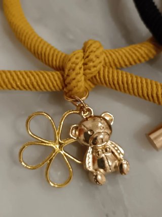 Pareja de pulseras con osito y flor