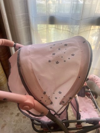 Carrito de muñecas rosa con estrellas