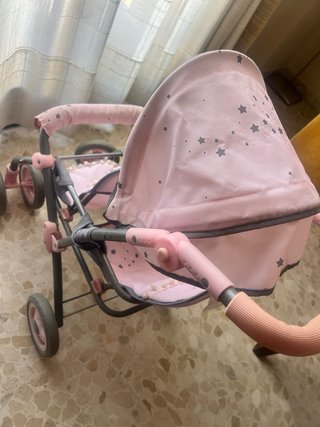 Carrito de muñecas rosa con estrellas