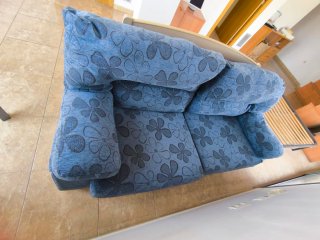 Sofá azul de tela con estampado floral