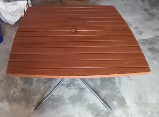 Mesa de exterior de madera de teca y aluminio.