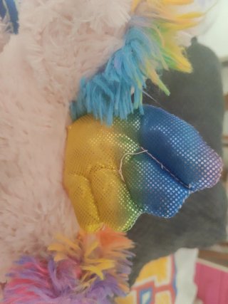 Unicornio de peluche rosa con detalles arcoíris