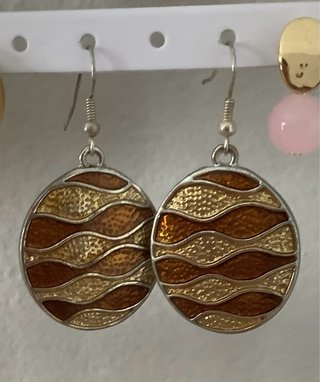 Pendientes She Is redondos en tonos dorado y cobre