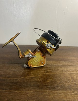 Carrete de pesca Mepps dorado