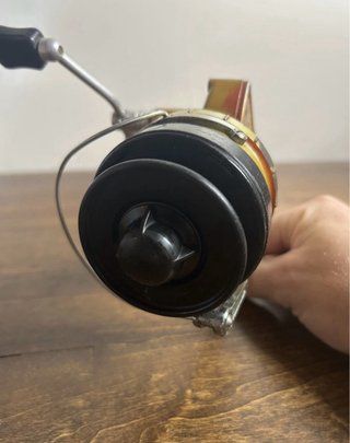 Carrete de pesca Mepps dorado