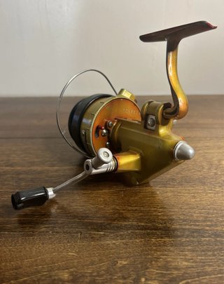 Carrete de pesca Mepps dorado