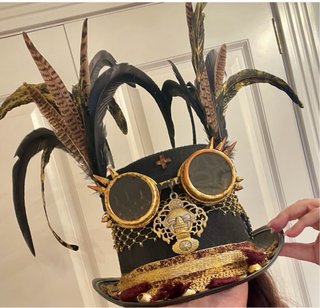 Sombrero de copa negro con adornos dorados