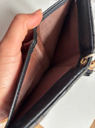 Cartera negra con detalles dorados