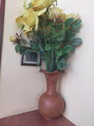 Vaso terracotta con rose gialle artificiali