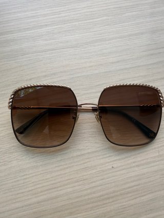 Gafas de sol Nina Ricci doradas con cadena