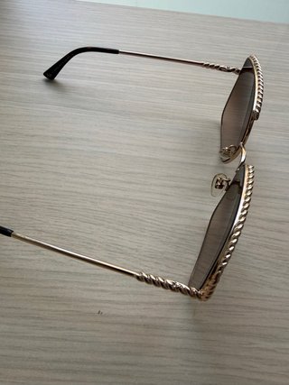 Gafas de sol Nina Ricci doradas con cadena