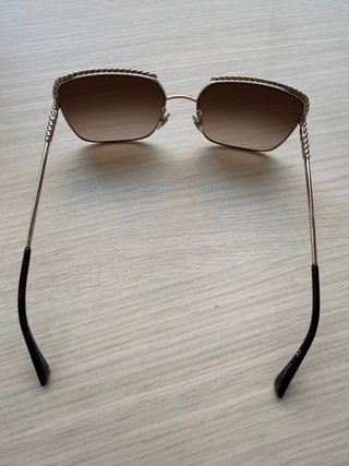 Gafas de sol Nina Ricci doradas con cadena