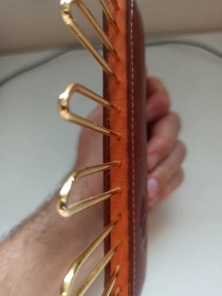 Colgador de corbatas de cuero con perchas doradas