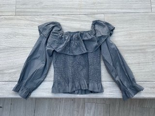 Blusa gris con volantes y manga larga