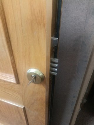 Puerta de calle madera con cerradura de seguridad.