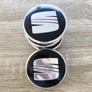 TAPABUJES SEAT 63mm NEGROS CON EMBLEMA PLATA