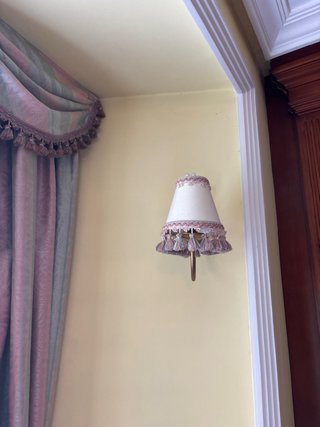 Lámpara de pared dorada con flecos