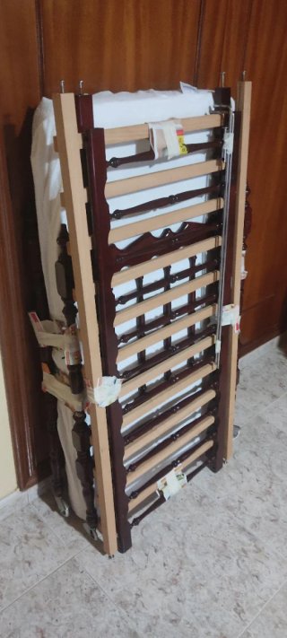 Cuna de bebé de madera oscura con ruedas