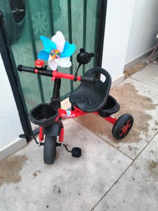 Triciclo infantil rojo con cestas