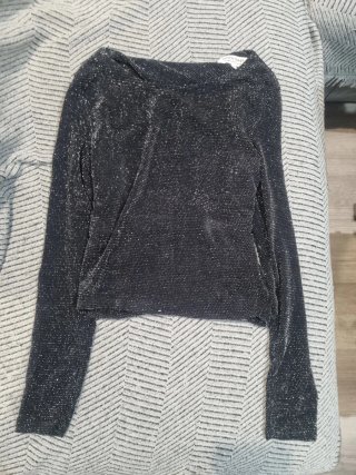 Elegante top negro brillante manga larga
