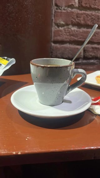 Taza de cerámica gris con platillo