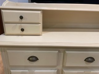 Aparador beige con puertas de cristal.
