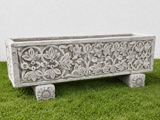 Jardinera de piedra con relieve floral