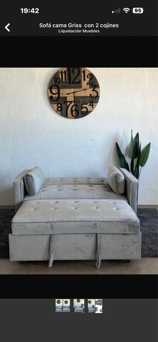Sofá cama gris con 2 cojines