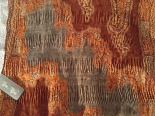 Foulard naranja y beige con pompones