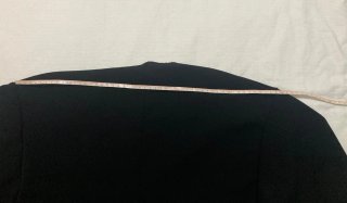 Capa negra con botón dorado