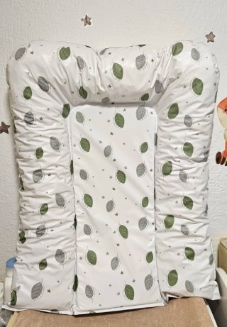 Cambiador de bebé con estampado de hojas.