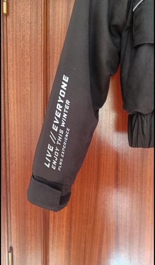 Chaqueta negra con gorro y detalles