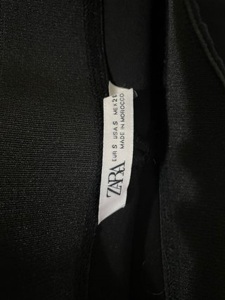 Pantalón negro con sobre falda y hebillas
