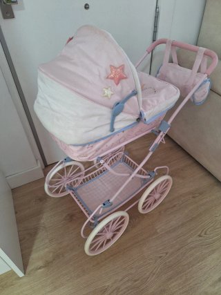 Carro de muñeca rosa con bebé