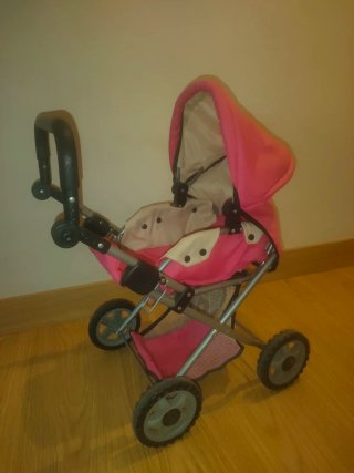 Carrito de bebé de juguete rosa